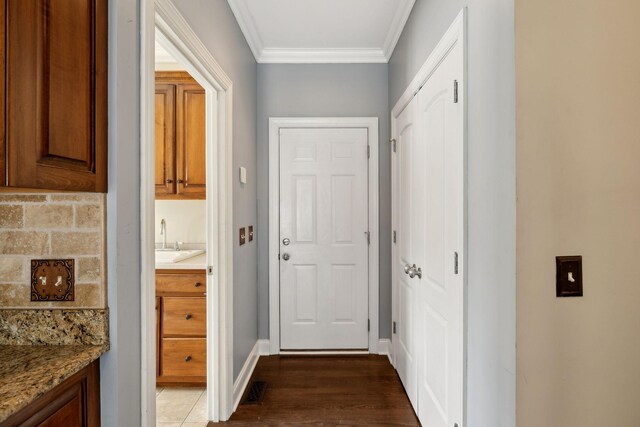 1769 Mayflower Dr, Columbia, TN 38401 - doorway to outside featuring ornamental molding, dark wood-type flooring, a sink, and baseboards
