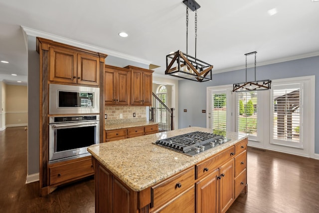 1769 Mayflower Dr, Columbia, TN 38401 - kitchen featuring appliances with stainless steel finishes, a chandelier, dark wood-style flooring, light stone counters, and crown molding