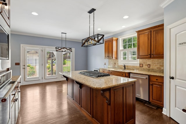 1769 Mayflower Dr, Columbia, TN 38401 - kitchen featuring appliances with stainless steel finishes, a center island, ornamental molding, decorative backsplash, and dark wood-style flooring