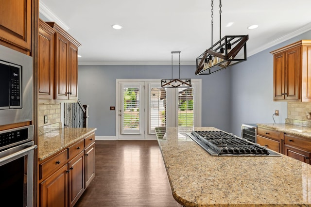 1769 Mayflower Dr, Columbia, TN 38401 - kitchen with stainless steel appliances, backsplash, brown cabinets, crown molding, and recessed lighting