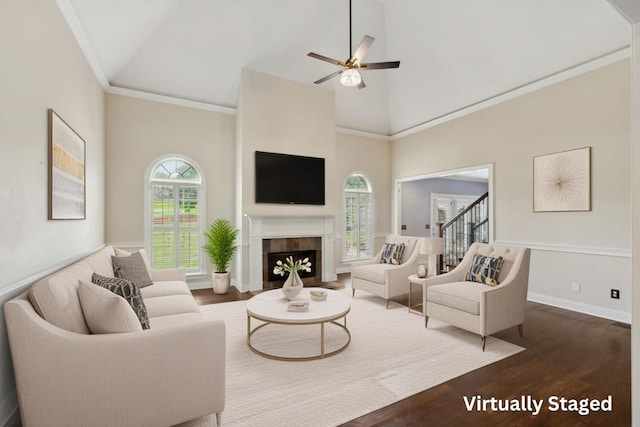 1769 Mayflower Dr, Columbia, TN 38401 - living area featuring dark wood-style flooring, a ceiling fan, high vaulted ceiling, a tile fireplace, and ornamental molding