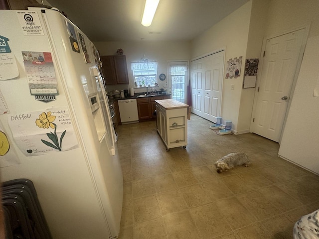 1040 Charlie Daniels Pkwy Unit 105, Mount Juliet, TN 37122 - kitchen featuring white appliances, a sink, a center island, tile countertops, and light tile patterned floors