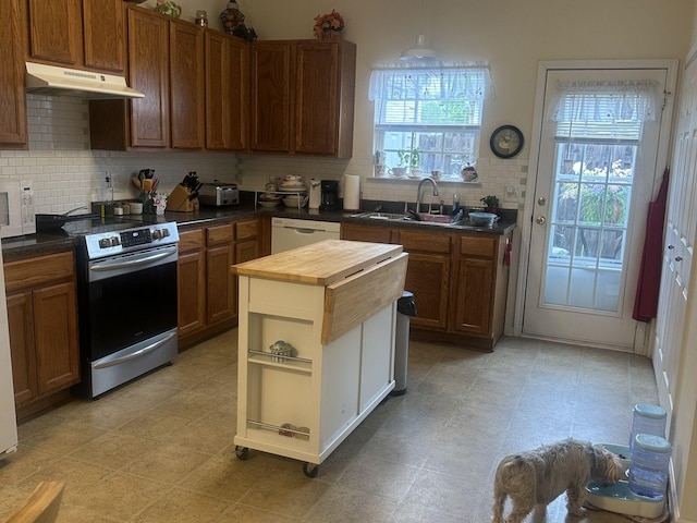 1040 Charlie Daniels Pkwy Unit 105, Mount Juliet, TN 37122 - kitchen with under cabinet range hood, butcher block countertops, a sink, stainless steel electric range, and plenty of natural light