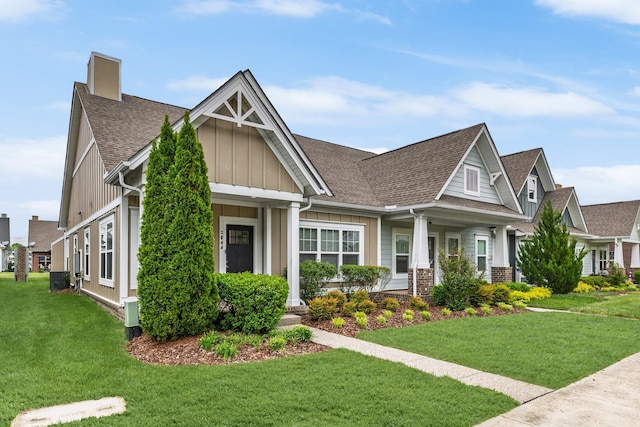 2044 Mainstream Dr, Franklin, TN 37064 - craftsman-style house with board and batten siding, a shingled roof, a front lawn, and a chimney