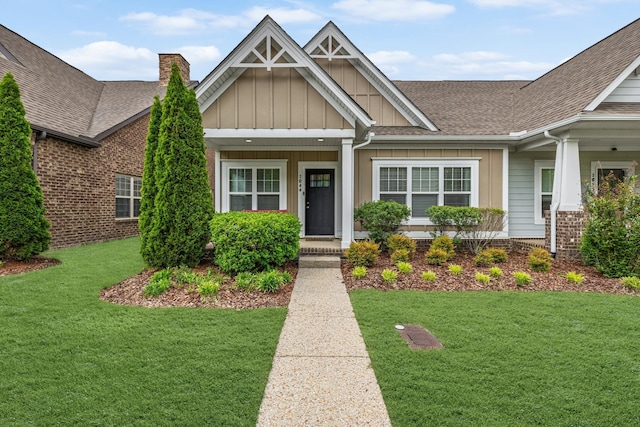 2044 Mainstream Dr, Franklin, TN 37064 - craftsman-style house with board and batten siding, roof with shingles, a front lawn, and a chimney