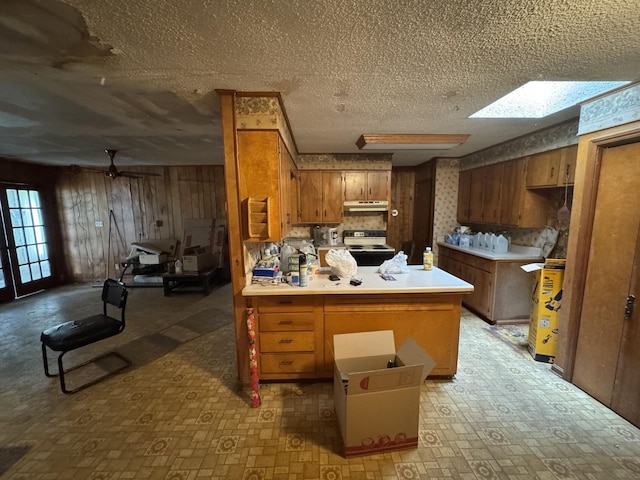 120 Red Bell Rd, Newbern, TN 38059 - kitchen featuring under cabinet range hood, electric range, brown cabinets, a peninsula, and ceiling fan