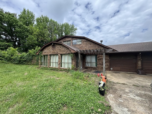 120 Red Bell Rd, Newbern, TN 38059 - view of front of property with brick siding, concrete driveway, an attached garage, a patio, and a gambrel roof