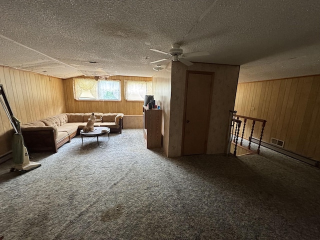 120 Red Bell Rd, Newbern, TN 38059 - carpeted living area with a ceiling fan, wood walls, and a textured ceiling