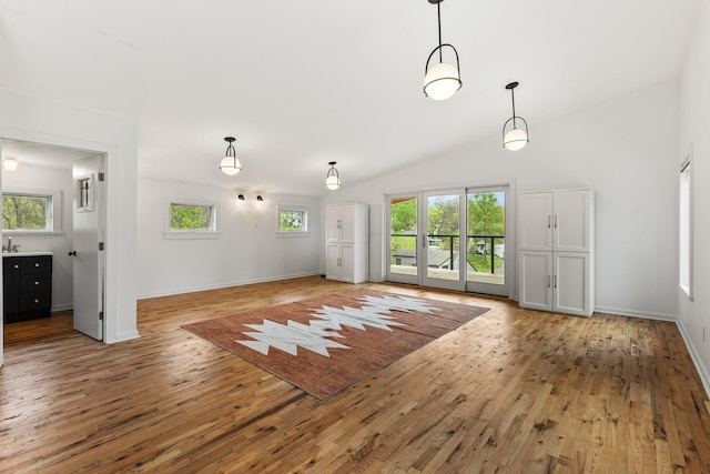 2013 Hackberry Ln, Nashville, TN 37206 - unfurnished living room with light wood-style floors, baseboards, and vaulted ceiling