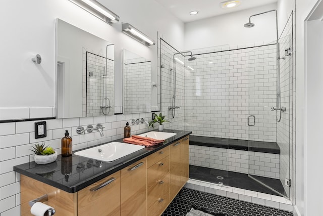 2013 Hackberry Ln, Nashville, TN 37206 - full bathroom with a stall shower, double vanity, and tasteful backsplash