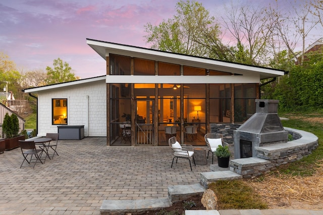 2013 Hackberry Ln, Nashville, TN 37206 - back of house at dusk featuring a sunroom and a patio area