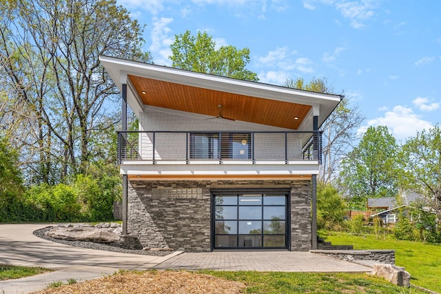 2013 Hackberry Ln, Nashville, TN 37206 - back of house with a balcony, a lawn, stone siding, and a patio area