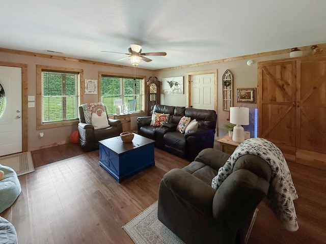 living area with a ceiling fan and wood finished floors