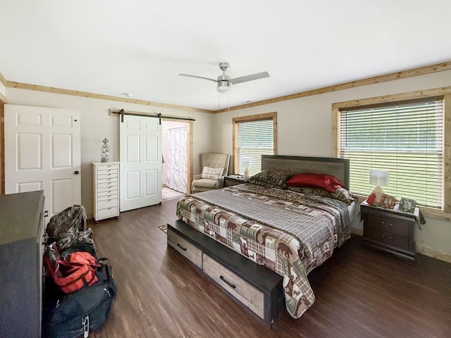 bedroom with wood finished floors, a barn door, and ceiling fan