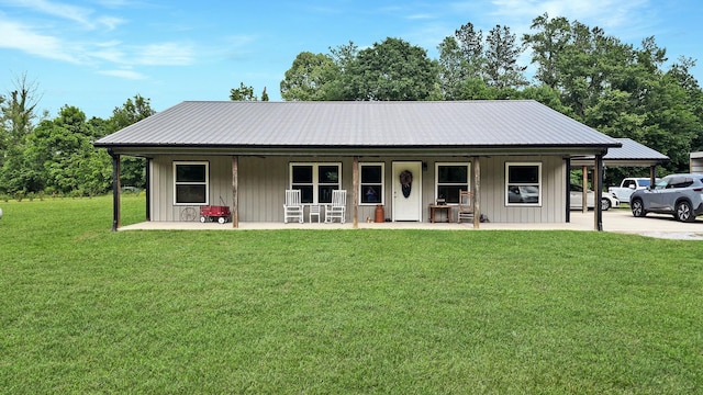 view of front facade with a porch, a front yard, metal roof, and board and batten siding