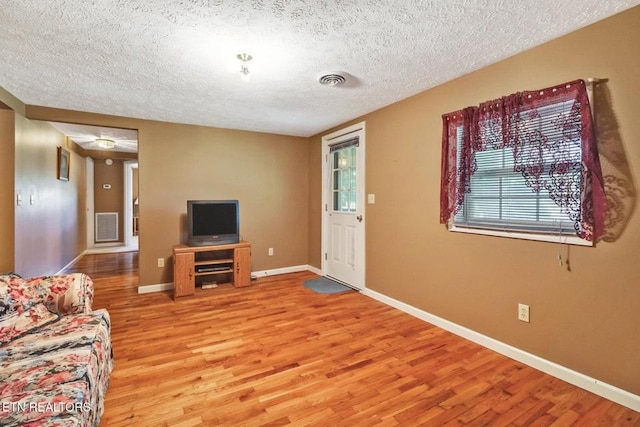 1729 Roslin Rd, Jamestown, TN 38556 - living area featuring a textured ceiling, light wood-style flooring, and plenty of natural light