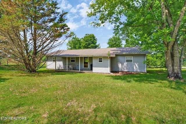 1729 Roslin Rd, Jamestown, TN 38556 - view of front of house featuring a metal roof, a front yard, and covered porch
