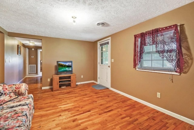 1729 Roslin Rd, Jamestown, TN 38556 - living room with a textured ceiling, light wood-style flooring, and plenty of natural light