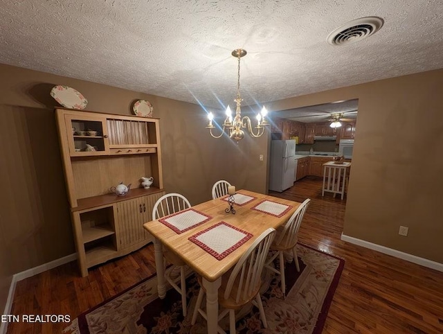 1729 Roslin Rd, Jamestown, TN 38556 - dining area with a textured ceiling, a chandelier, dark wood-style flooring, and a ceiling fan