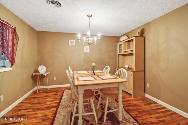 1729 Roslin Rd, Jamestown, TN 38556 - dining area featuring wood finished floors, a textured ceiling, and a chandelier