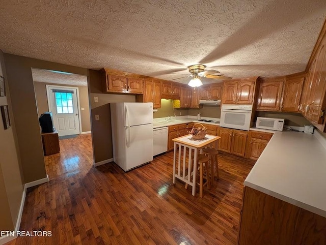 1729 Roslin Rd, Jamestown, TN 38556 - kitchen with white appliances, dark wood-style flooring, under cabinet range hood, a ceiling fan, and a textured ceiling