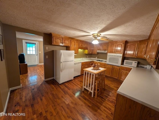 1729 Roslin Rd, Jamestown, TN 38556 - kitchen with white appliances, dark wood-style flooring, light countertops, under cabinet range hood, and a ceiling fan