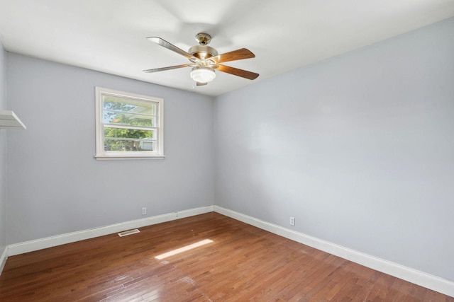 empty room featuring baseboards, a ceiling fan, and wood finished floors