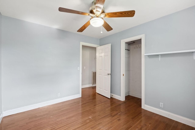unfurnished bedroom with baseboards, wood finished floors, and a ceiling fan
