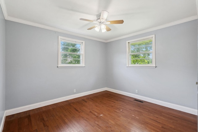 empty room featuring baseboards, wood-type flooring, a ceiling fan, and ornamental molding