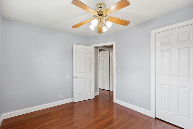 unfurnished bedroom with wood finished floors, baseboards, and a ceiling fan