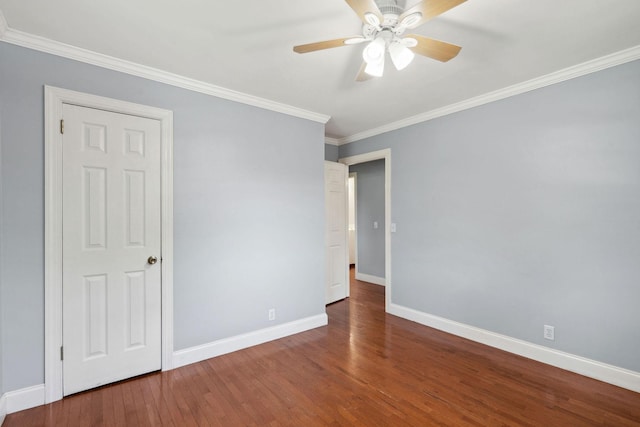 unfurnished bedroom with wood finished floors, baseboards, crown molding, and a ceiling fan