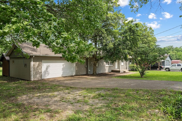 obstructed view of property with a front lawn, concrete driveway, and a garage