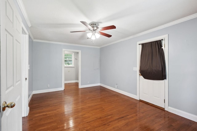 unfurnished bedroom with wood finished floors, baseboards, and crown molding
