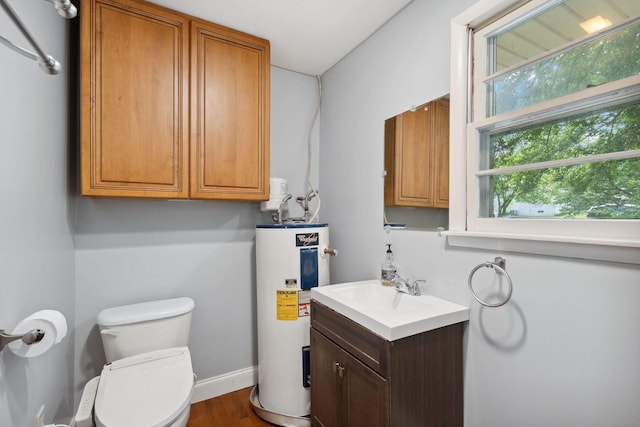 bathroom featuring electric water heater, wood finished floors, toilet, vanity, and baseboards