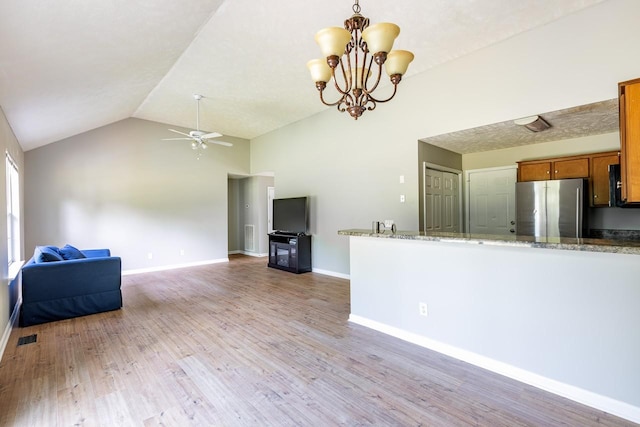 309 Yacht Ct, Smyrna, TN 37167 - kitchen with freestanding refrigerator, brown cabinetry, vaulted ceiling, a ceiling fan, and baseboards