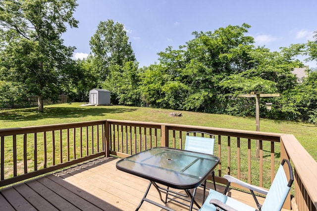 309 Yacht Ct, Smyrna, TN 37167 - wooden terrace featuring a shed, an outdoor structure, outdoor dining space, and view of scattered trees