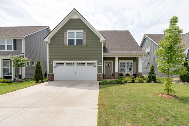 craftsman house featuring an attached garage, driveway, a front lawn, and stone siding