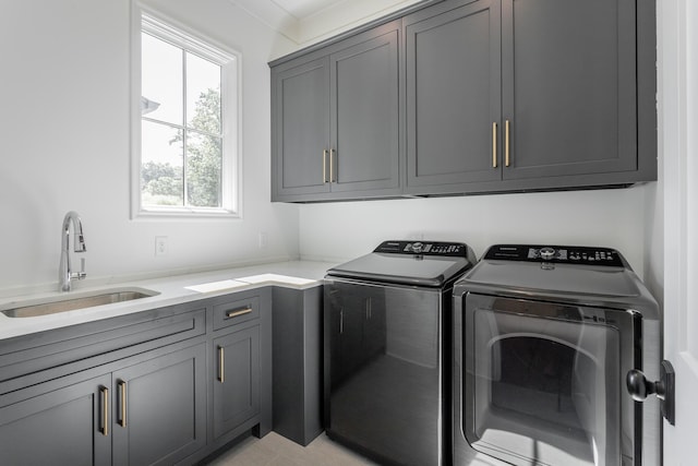 laundry area featuring independent washer and dryer and cabinet space