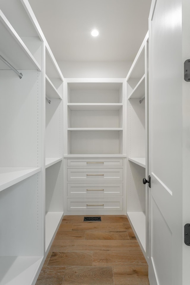 walk in closet featuring light wood finished floors