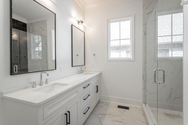 full bathroom with marble finish flooring, baseboards, a marble finish shower, double vanity, and crown molding