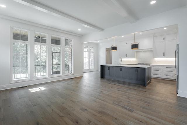 kitchen featuring a sink, beamed ceiling, white cabinetry, dark wood-style floors, and recessed lighting