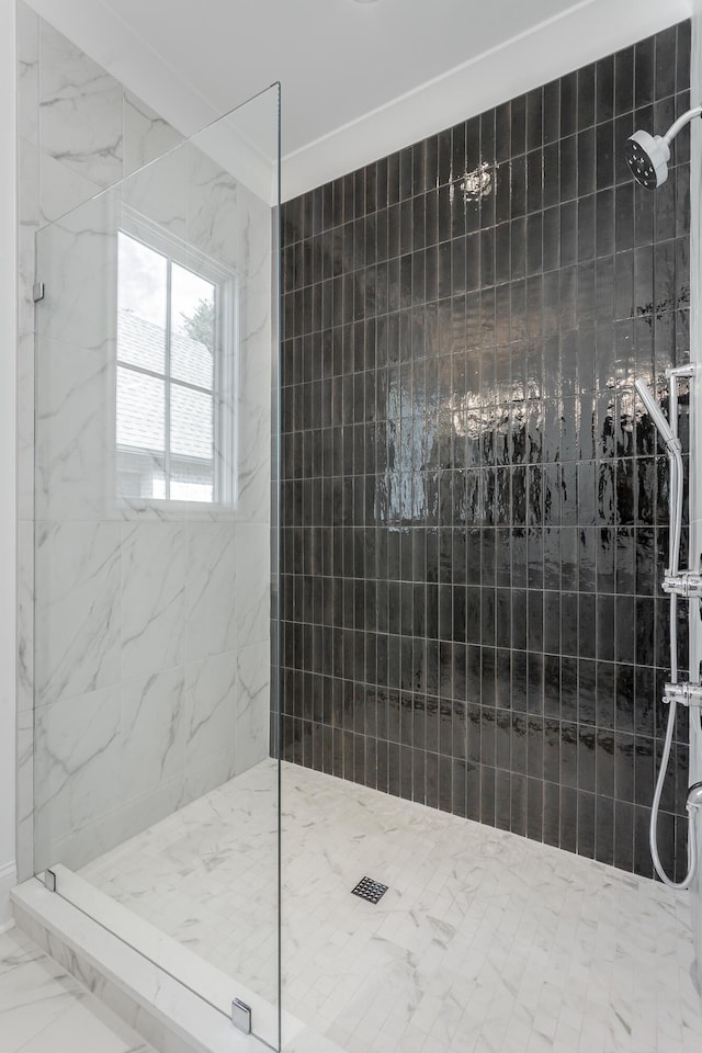 full bath with marble look tile flooring and a walk in shower