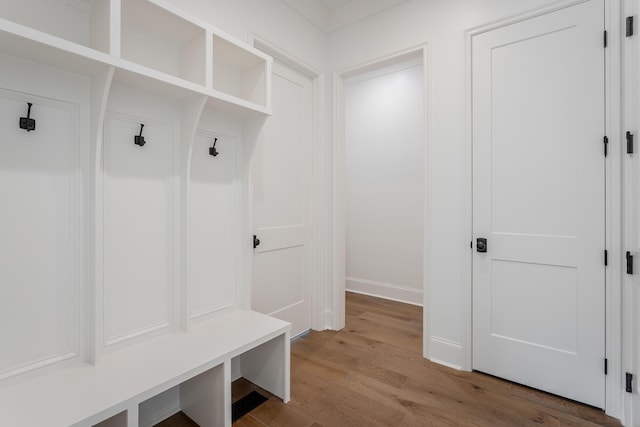 mudroom featuring wood finished floors and baseboards