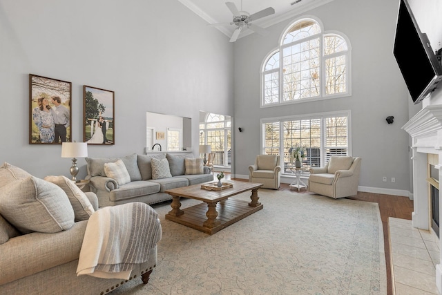 9727 Chestnut Hill Ln, Chattanooga, TN 37421 - living area featuring ornamental molding, a fireplace with flush hearth, a towering ceiling, wood finished floors, and ceiling fan