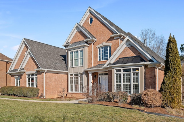 9727 Chestnut Hill Ln, Chattanooga, TN 37421 - view of front facade featuring brick siding, a front yard, a standing seam roof, and a shingled roof