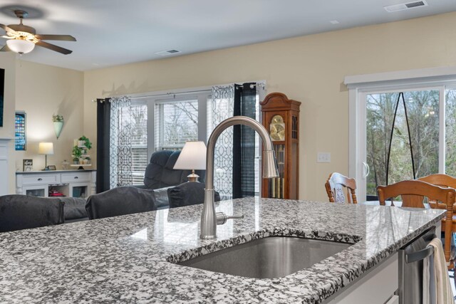 7587 Highborne Ln, Ooltewah, TN 37363 - kitchen featuring a sink, light stone countertops, open floor plan, ceiling fan, and stainless steel dishwasher