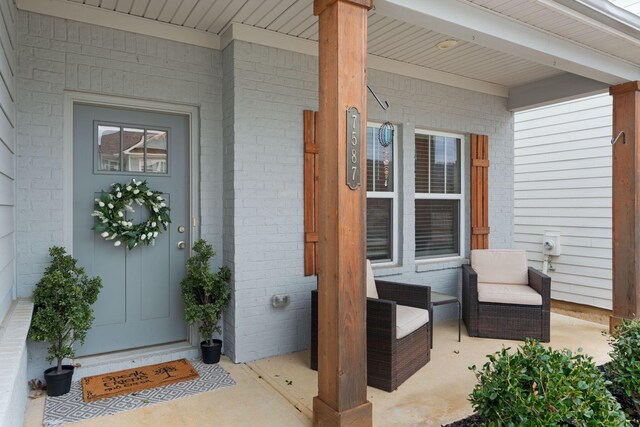 7587 Highborne Ln, Ooltewah, TN 37363 - entrance to property featuring a porch and brick siding