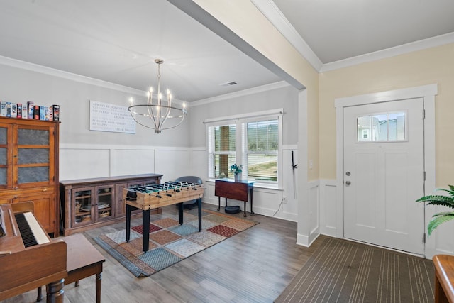 7587 Highborne Ln, Ooltewah, TN 37363 - foyer entrance featuring a decorative wall, wood finished floors, a chandelier, crown molding, and wainscoting