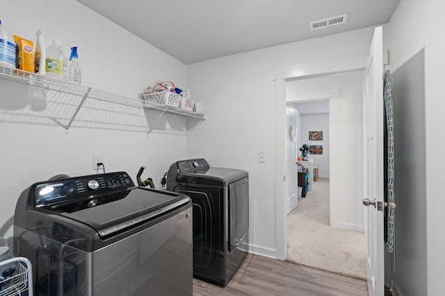 7587 Highborne Ln, Ooltewah, TN 37363 - laundry room with washing machine and dryer, wood finished floors, and baseboards