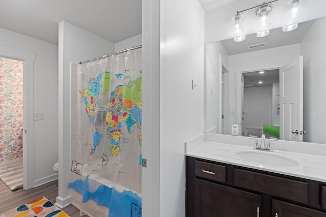 7587 Highborne Ln, Ooltewah, TN 37363 - bathroom with wood finished floors, toilet, vanity, and curtained shower